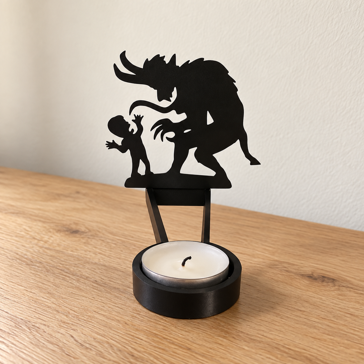 Demon and child silhouette candle holder - horned beast leaning over a small child, black metal tealight holder